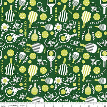 Image of the Pickleball Main Green quilting cotton fabric by Riley Blake Designs. Features pickleball items on a green background. Cute Little Fabric Shop