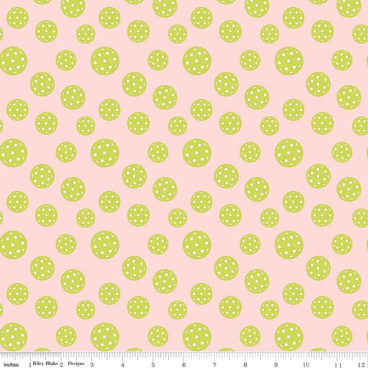 Image of the Pickleball Pickleballs Blush quilting cotton fabric by Riley Blake Designs. Features pickleballs on a pink background. Cute Little Fabric Shop
