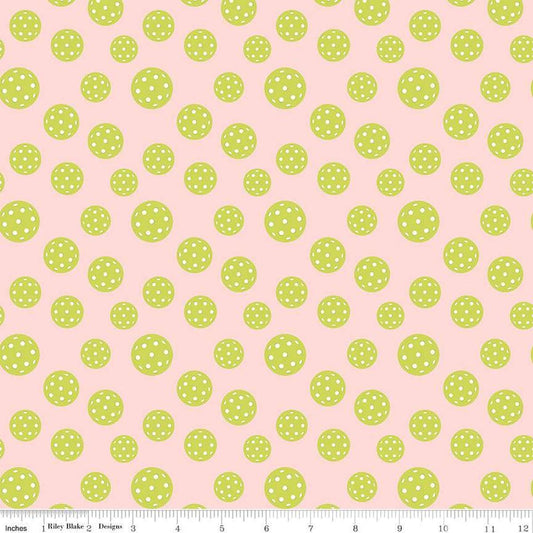 Image of the Pickleball Pickleballs Blush quilting cotton fabric by Riley Blake Designs. Features pickleballs on a pink background. Cute Little Fabric Shop