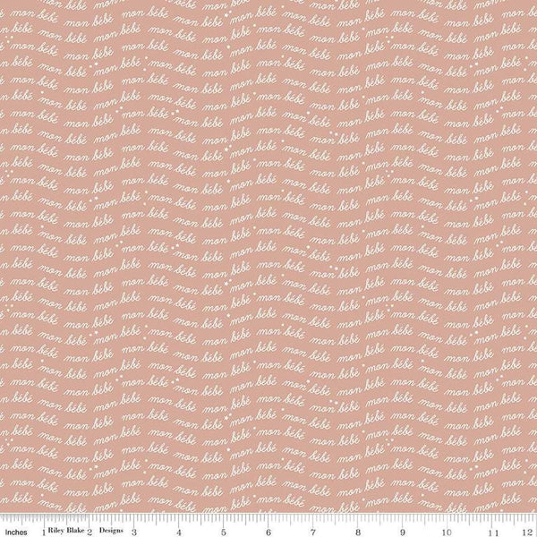 Image of the Cozy Bebe Text Mellow Rose quilting cotton by Riley Blake Designs. Features text on a pink background. Cute Little Fabric Shop