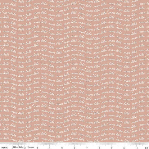 Image of the Cozy Bebe Text Mellow Rose quilting cotton by Riley Blake Designs. Features text on a pink background. Cute Little Fabric Shop