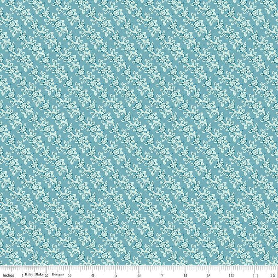 Image of the Emma Mrs. Weston quilting cotton fabric by Riley Blake Designs. Features leaves on a blue background. Cute Little Fabric Shop
