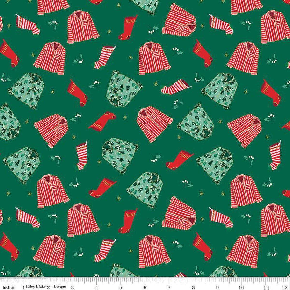 Image of the Flannel Christmas Pajamas Green quilting cotton fabric by Riley Blake Designs. Features pajamas on a green background. Cute Little Fabric Shop