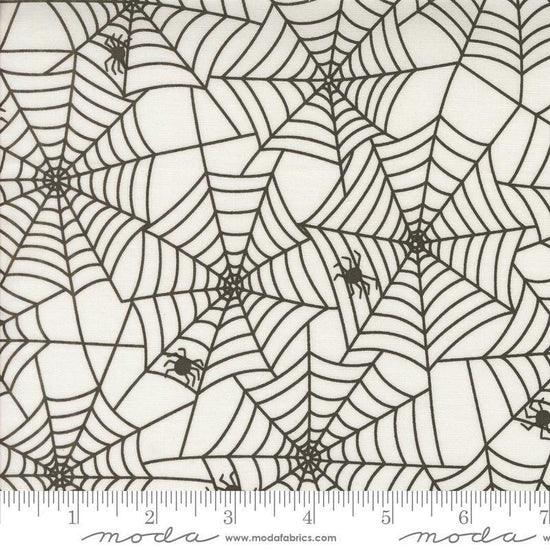 Image of the Fab Boo Lous Webs Ghostly quilting cotton fabric. Features spiderwebs on a cream background. Cute Little Fabric Shop