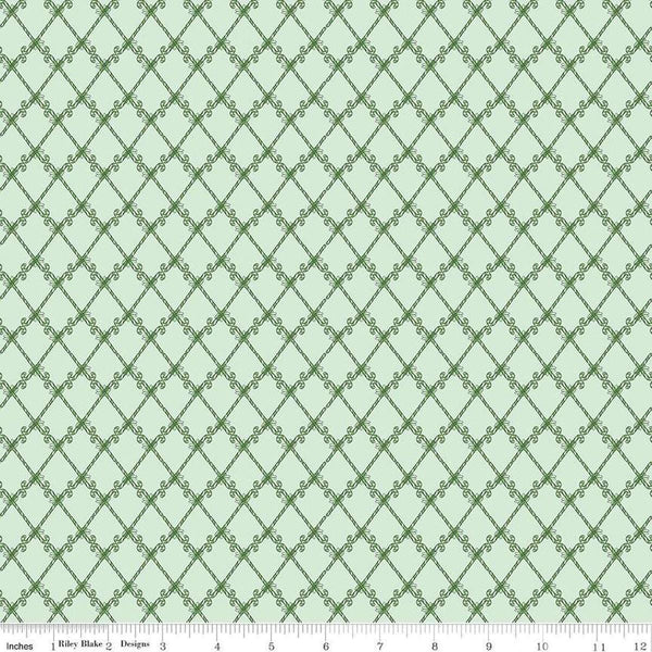 Image of the Mistletoe & Holly Candy Canes Hint of Mint quilting cotton fabric by Riley Blake Designs. Features candy on a green background. Cute Little Fabric Shop
