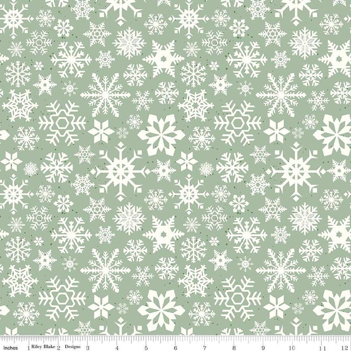 Image of the Mistletoe & Holly Snowflakes Sage quilting cotton fabric by Riley Blake Designs. Features snowflakes on a green background. Cute Little Fabric Shop