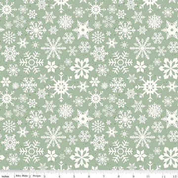 Image of the Mistletoe & Holly Snowflakes Sage quilting cotton fabric by Riley Blake Designs. Features snowflakes on a green background. Cute Little Fabric Shop