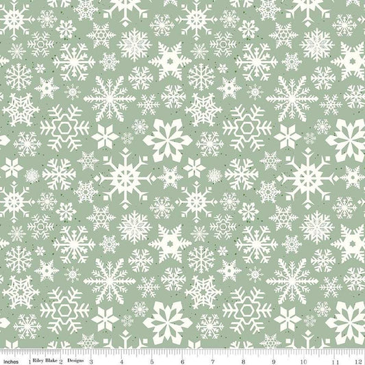 Image of the Mistletoe & Holly Snowflakes Sage quilting cotton fabric by Riley Blake Designs. Features snowflakes on a green background. Cute Little Fabric Shop
