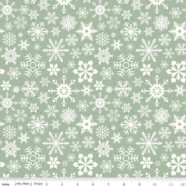 Image of the Mistletoe & Holly Snowflakes Sage quilting cotton fabric by Riley Blake Designs. Features snowflakes on a green background. Cute Little Fabric Shop