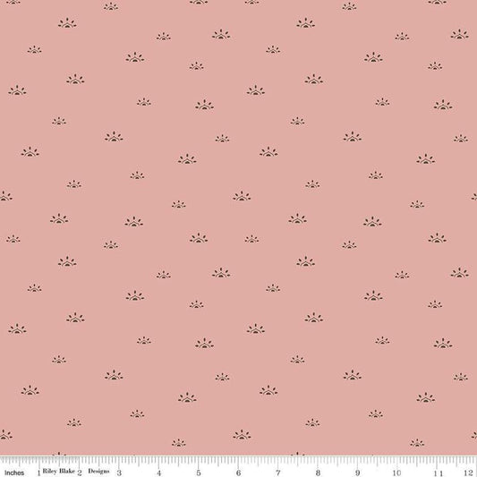 Image of the Winged Medley Woodblock Dusty Rose quilting cotton fabric. Features suns on a coral background. Cute Little Fabric Shop