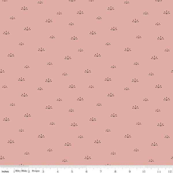Image of the Winged Medley Woodblock Dusty Rose quilting cotton fabric. Features suns on a coral background. Cute Little Fabric Shop