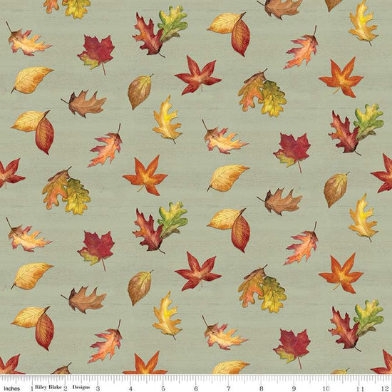 Image of the Covered Bridges in Fall Leaf Toss Sage quilting cotton fabric by Riley Blake Designs. Features leaves on a green background. Cute Little Fabric Shop