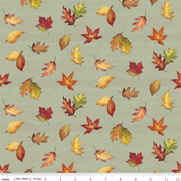 Image of the Covered Bridges in Fall Leaf Toss Sage quilting cotton fabric by Riley Blake Designs. Features leaves on a green background. Cute Little Fabric Shop