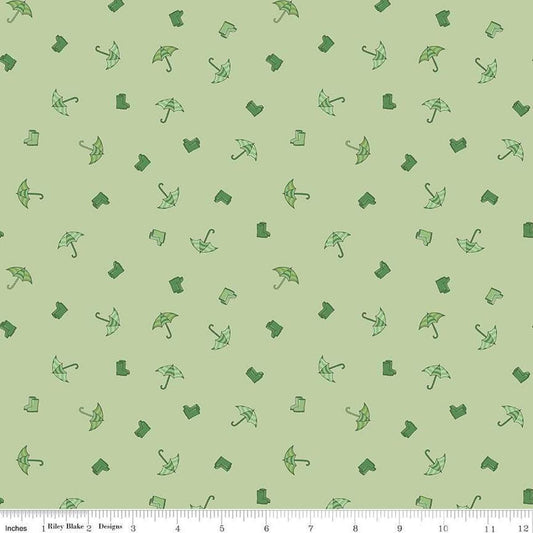 Image of the Cloudburst Umbrellas Green quilting cotton fabric by Riley Blake Designs. Features rainboots on a green background. Cute Little Fabric Shop