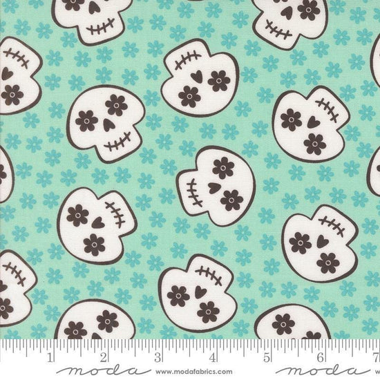 Image of the Fab Boo Lous Skull Aqua quilting cotton fabric. Features skulls on a blue background. Cute Little Fabric Shop