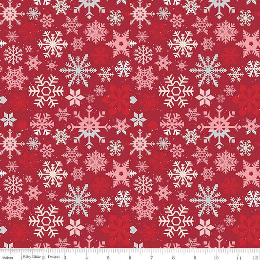 Image of the Mistletoe & Holly Snowflakes Barn Red quilting cotton fabric by Riley Blake Designs. Features snowflakes on a red background. Cute Little Fabric Shop