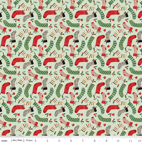 Image of the Charming Christmas Stockings Mint quilting cotton fabric by Riley Blake Designs. Features holidays on a green background. Cute Little Fabric Shop