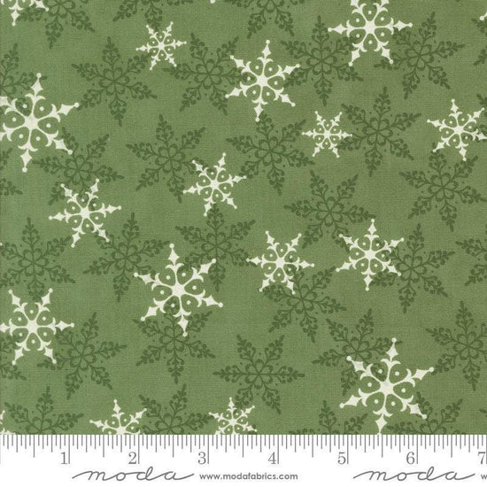 Image of the Winter Friends Woodland Pine quilting cotton fabric by Moda Fabrics. Features snowflakes on a green background. Cute Little Fabric Shop