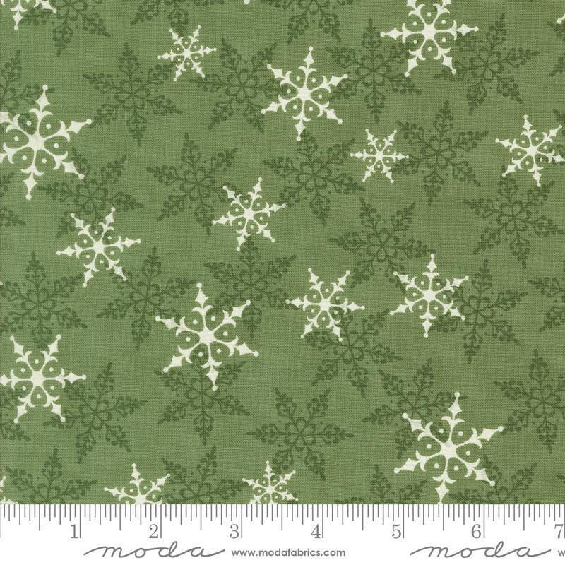 Image of the Winter Friends Woodland Pine quilting cotton fabric by Moda Fabrics. Features snowflakes on a green background. Cute Little Fabric Shop
