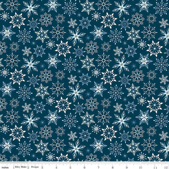 Image of the Winter Magic Snowflakes Navy quilting cotton fabric by Riley Blake Designs. Features snowflakes on a blue background. Cute Little Fabric Shop