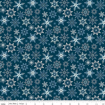 Image of the Winter Magic Snowflakes Navy quilting cotton fabric by Riley Blake Designs. Features snowflakes on a blue background. Cute Little Fabric Shop