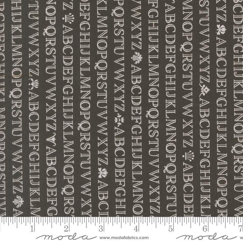 Image of the Agatha Road Alphabet Midnight quilting cotton fabric by Moda Fabrics. Features letters on a black background. Cute Little Fabric Shop