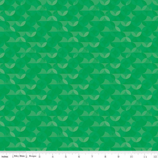 Image of the New Box of Crayons Kaleidoscope Green Quilting Cotton Fabric by Riley Blake Designs. Features orange peel on a green background. Cute Little Fabric Shop