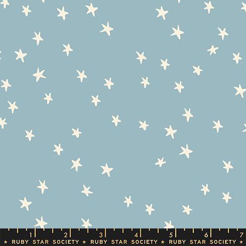 Image of the Starry New Blender Stars Soft Blue quilting cotton fabric by Ruby Star Society for Moda Fabrics. Features small stars on a blue background. Cute Little Fabric Shop