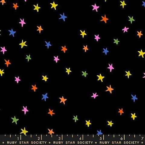 Image of the Starry New Blender Stars Vivid Rainbow quilting cotton fabric by Ruby Star Society for Moda Fabrics. Features small stars on a black background. Cute Little Fabric Shop