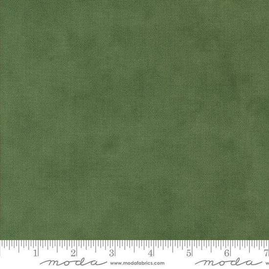Image of the Winter Friends Solid Spruce quilting cotton fabric by Moda Fabrics. Features texture on a green background. Cute Little Fabric Shop