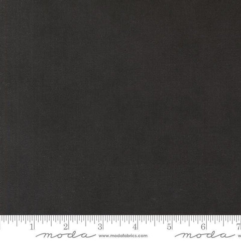 Image of the Winter Friends Solid Charcoal Black quilting cotton fabric by Moda Fabrics. Features texture on a black background. Cute Little Fabric Shop