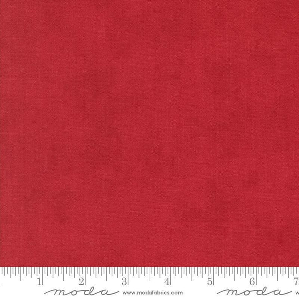 Image of the Winter Friends Solid Berry Red quilting cotton fabric by Moda Fabrics. Features texture on a red background. Cute Little Fabric Shop