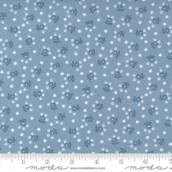 Image of the Nantucket Summer Fairground Light Blue quilting cotton fabric by Camille Roskelley for Moda Fabrics. Features florals on a blue background. Cute Little Fabric Shop