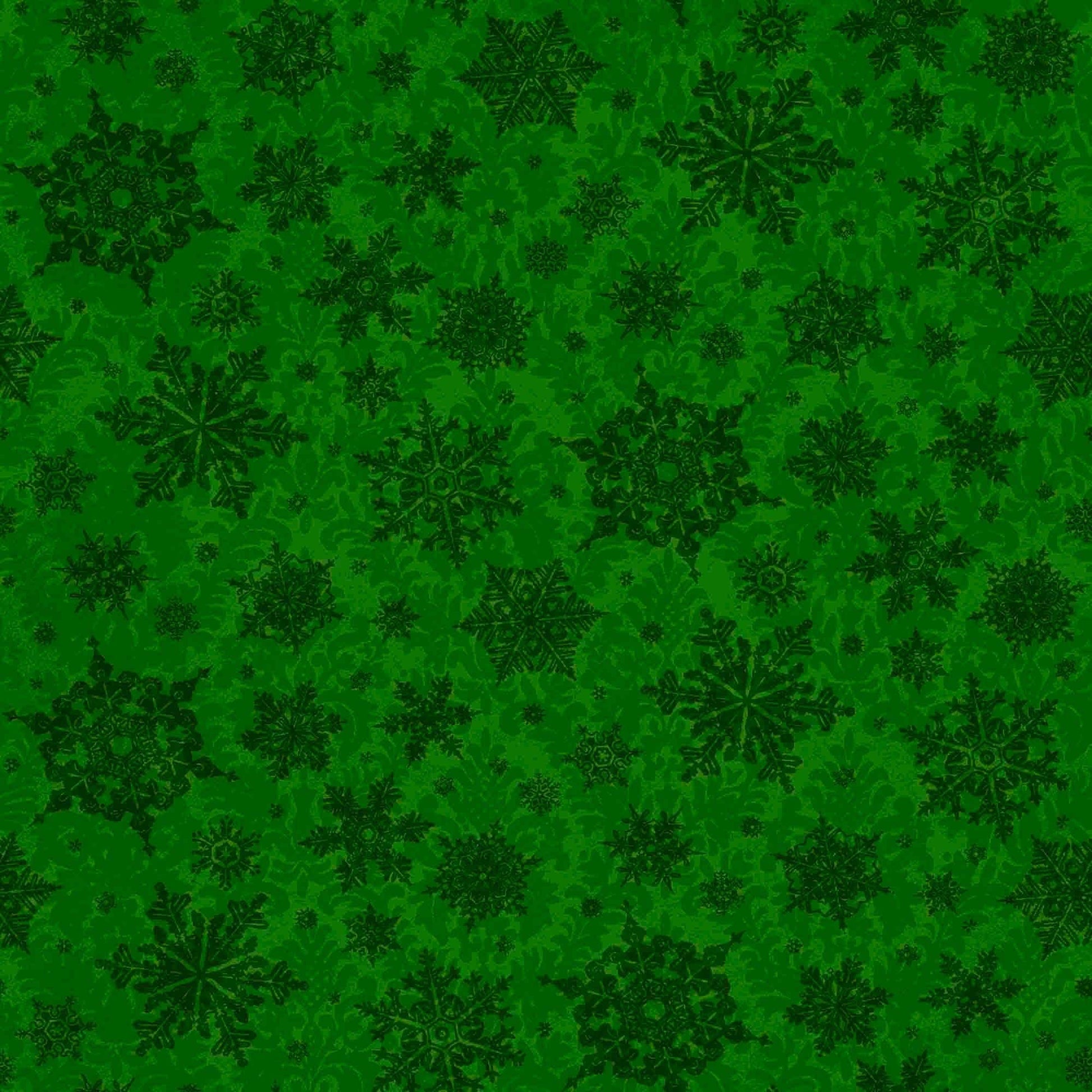 Image of the Poinsettia Greetings Poinsettia Tonal forest quilting cotton fabric by QT Fabrics. Features snowflakes on a green background. Cute Little Fabric Shop