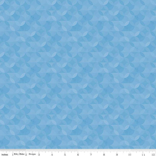 Image of the New Box of Crayons Kaleidoscope Sky Quilting Cotton Fabric by Riley Blake Designs. Features orange peel on a blue background. Cute Little Fabric Shop