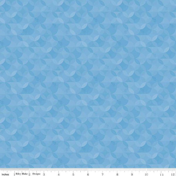 Image of the New Box of Crayons Kaleidoscope Sky Quilting Cotton Fabric by Riley Blake Designs. Features orange peel on a blue background. Cute Little Fabric Shop