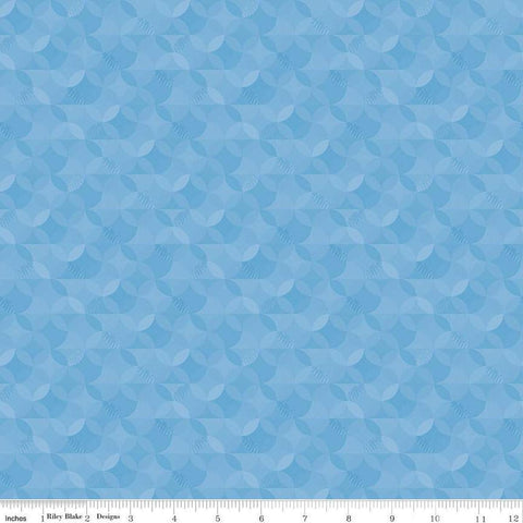 Image of the New Box of Crayons Kaleidoscope Sky Quilting Cotton Fabric by Riley Blake Designs. Features orange peel on a blue background. Cute Little Fabric Shop