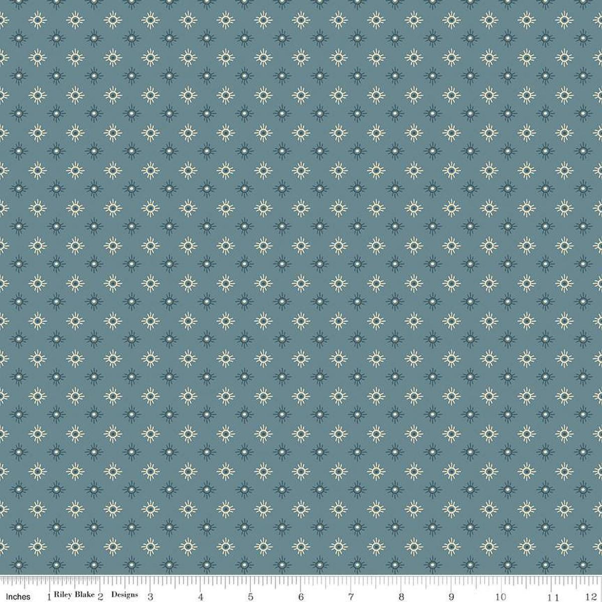 Image of John Wayne American West Sun Denim quilting cotton fabric by Riley Blake Official Product for Riley Blake Designs. Features suns on a blue background. Cute Little Fabric Shop