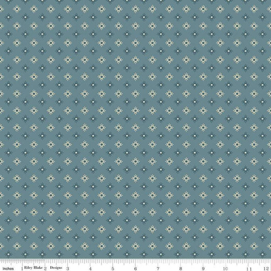 Image of John Wayne American West Sun Denim quilting cotton fabric by Riley Blake Official Product for Riley Blake Designs. Features suns on a blue background. Cute Little Fabric Shop