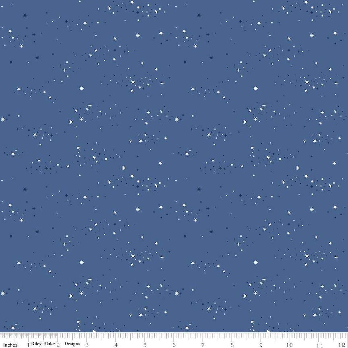 Image of Essence Starlight Denim quilting cotton fabric by Fran Gulick for Riley Blake Designs. Features stars on a blue background. Cute Little Fabric Shop