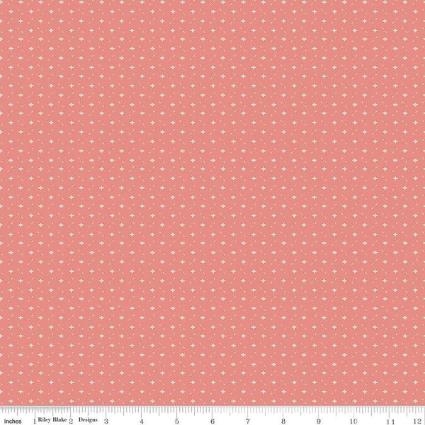 Image of Ivy Reese Ditsy Coral quilting cotton fabric by Deena Rutter for Riley Blake Designs. Features small shapes on a pink background. Cute Little Fabric Shop