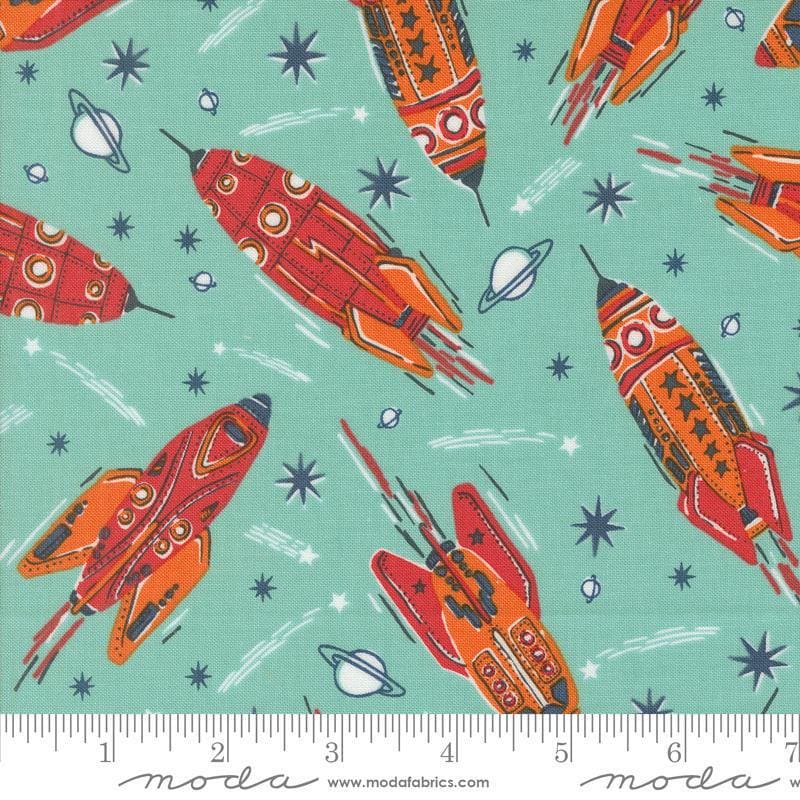 Image of the 321 Blast Off Rockets Blue Nebula quilting cotton fabric by Moda Fabrics. Features vintage spaceships on a blue background. Cute Little Fabric Shop
