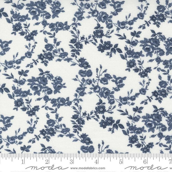 Image of the Nantucket Summer Surfside Cream Navy quilting cotton fabric by Camille Roskelley for Moda Fabrics. Features flowers on a blue background. Cute Little Fabric Shop