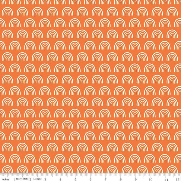 Image of the Two by Two Chasing Rainbows Orange quilting cotton fabric by Cayla Naylor for Riley Blake Designs. Features rainbows on a orange background. Cute Little Fabric Shop