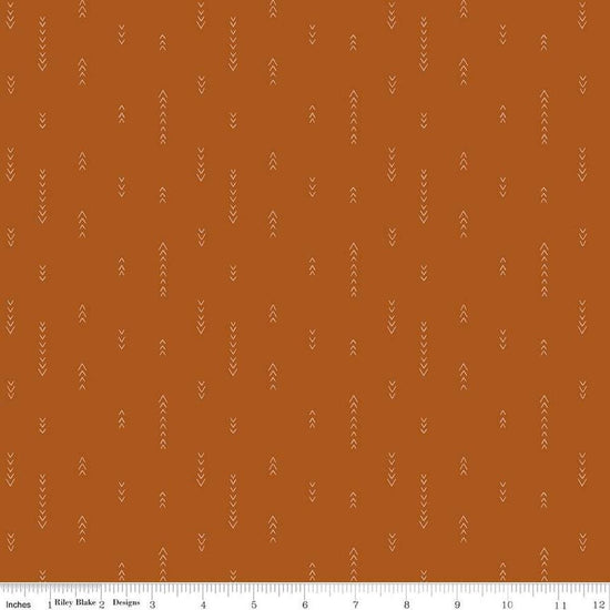 Image of Olive Grove Arrows Terracotta quilting cotton fabric by Amber Elliot for Riley Blake Designs. Features arrows on an orange background. Cute Little Fabric Shop