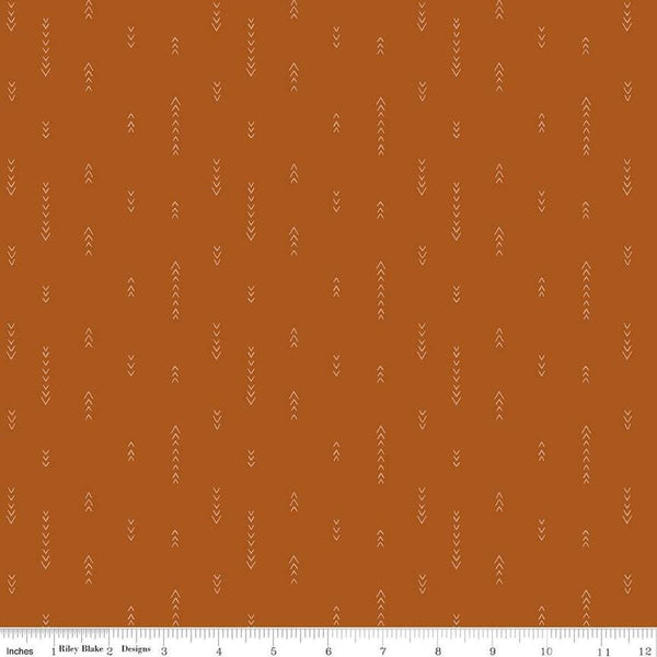 Image of Olive Grove Arrows Terracotta quilting cotton fabric by Amber Elliot for Riley Blake Designs. Features arrows on an orange background. Cute Little Fabric Shop