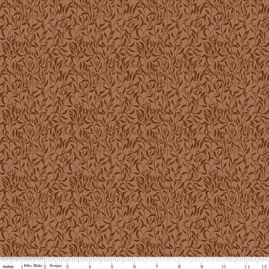 Image of Let's Wander Leaflets Rust quilting cotton fabric by Casey Cometti for Riley Blake Designs. Features leaves on a brown background. Cute Little Fabric Shop