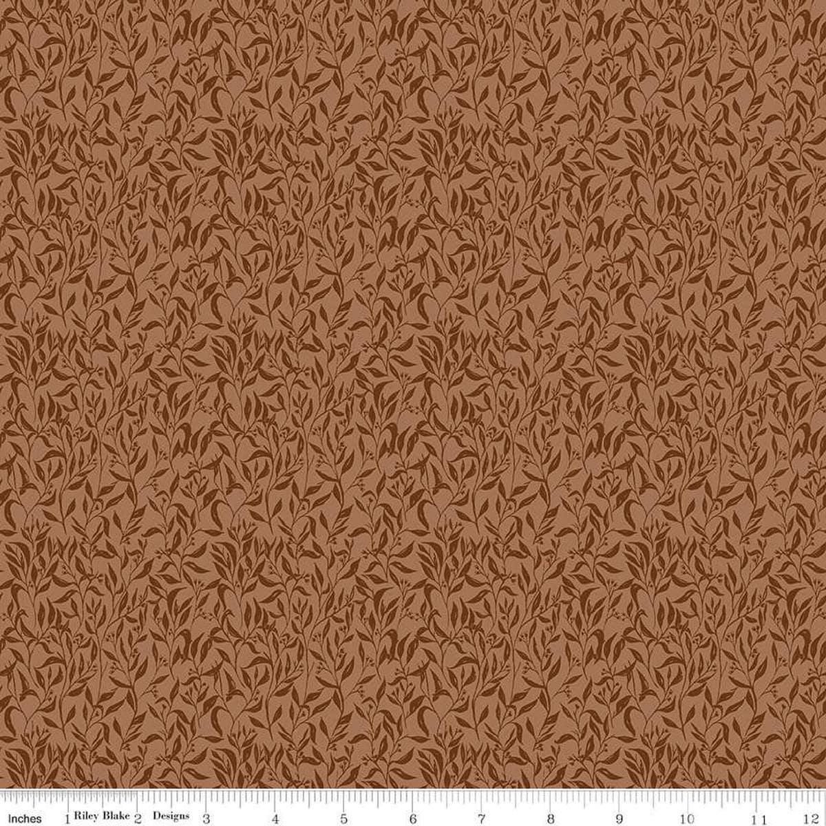 Image of Let's Wander Leaflets Rust quilting cotton fabric by Casey Cometti for Riley Blake Designs. Features leaves on a brown background. Cute Little Fabric Shop