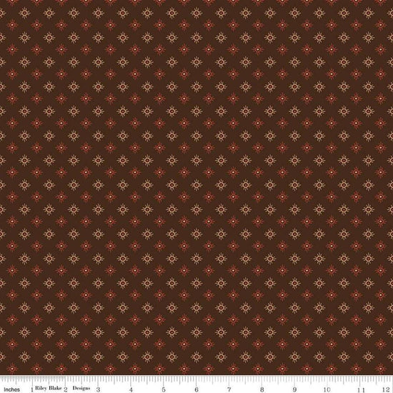 Image of John Wayne American West Sun Brown quilting cotton fabric by Riley Blake Official Product for Riley Blake Designs. Features suns on a brown background. Cute Little Fabric Shop