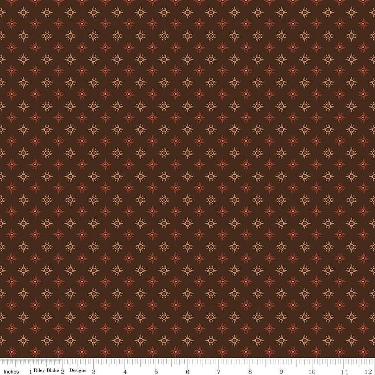 Image of John Wayne American West Sun Brown quilting cotton fabric by Riley Blake Official Product for Riley Blake Designs. Features suns on a brown background. Cute Little Fabric Shop